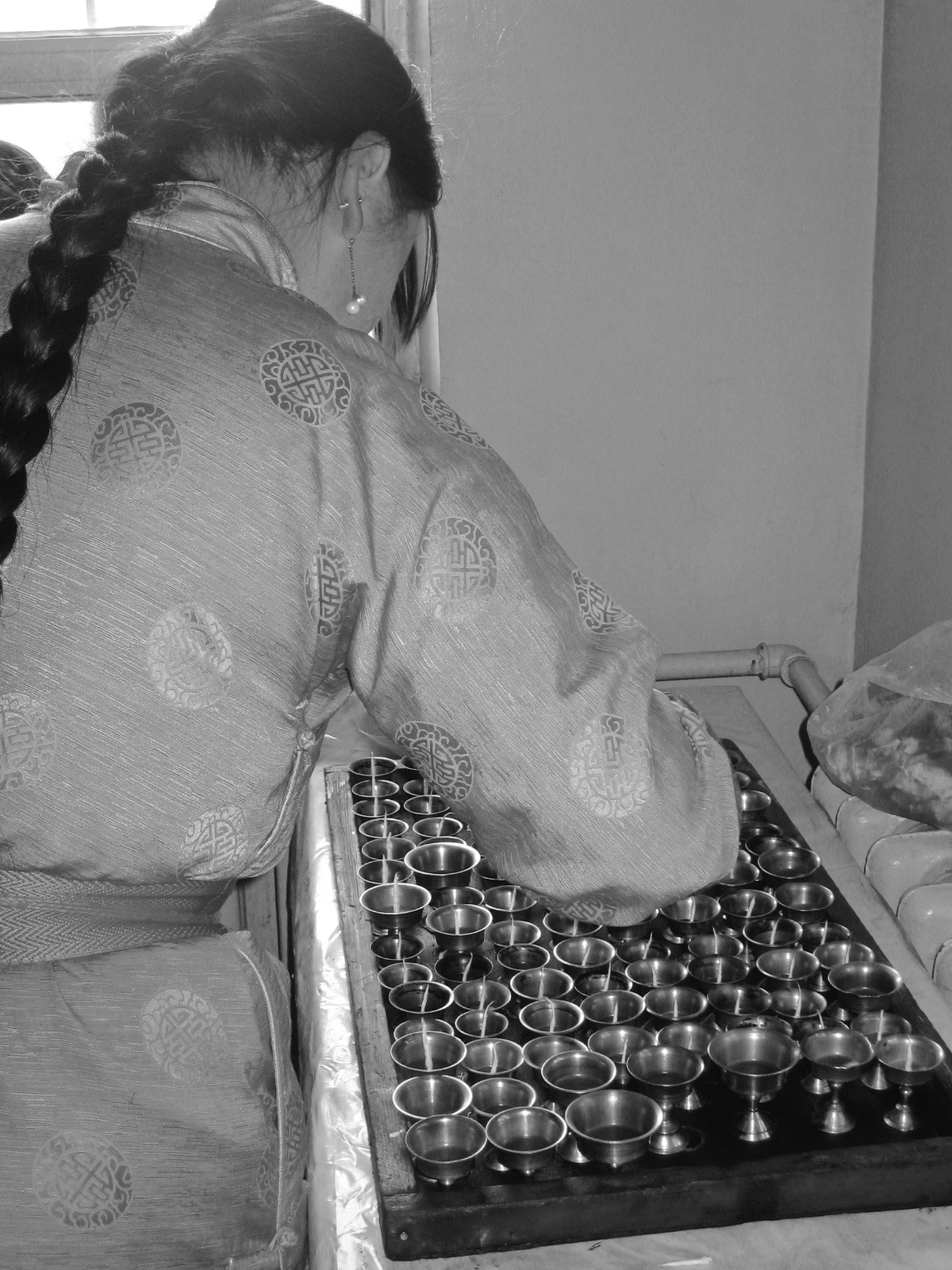 A Tugsbayasgalant Women's Centre ani preparing the traditional one hundred butter lamp offering Ulaanbaator. 21 Sept 2008 Photograph: C Pleteshner