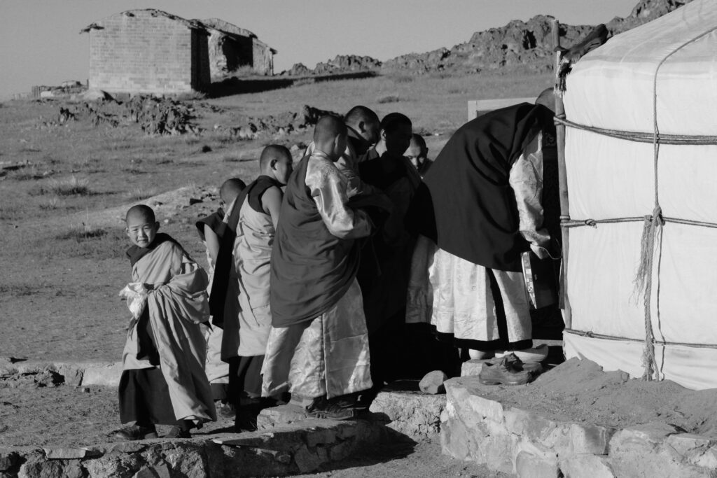 Zava Damdin (1976- ) leading his novice lams and others into one of the Teacher’s gers for the daily 8am class (which would go until lunchtime) at Delgeruun Choira in the Gobi Desert. I often sat in for these classes too. What a privilage! L.Pagchog (pictured left) looking at me with the camera, thinking “who is this person in a women’s body taking a photo of me?” Nearly two decades later, we both continue to study with Zava Rinpoche (1976- ) and over the years have become firm and trustworthy kalyanamittra-friends. Photograph: C.Pleteshner. 18 September 2005.