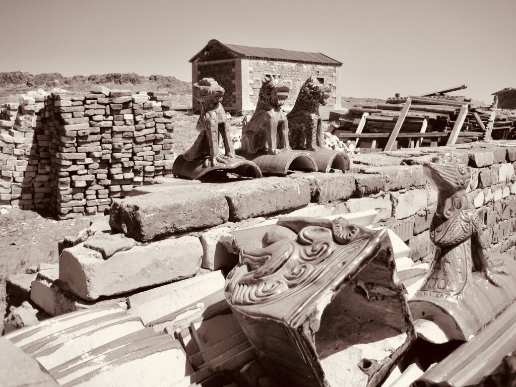 The early days. Stacks of the some of the building materials used for the successful Soyombot Oron-Delgeruun Choira Reconstruction Project in the Gobi Desert, Mongolia. 15 July 2005. Photograph: C.Pleteshner